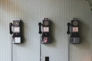 3 vintage phones on wall