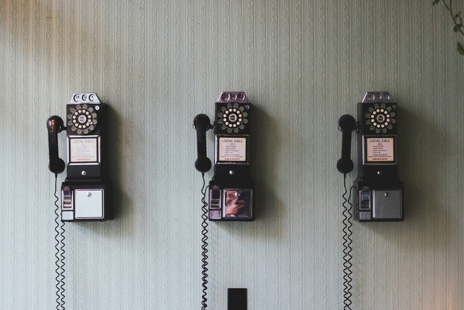 3 vintage phones on wall