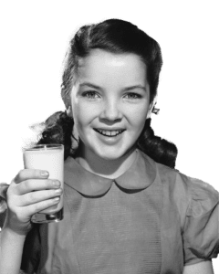 girl holding glass of milk