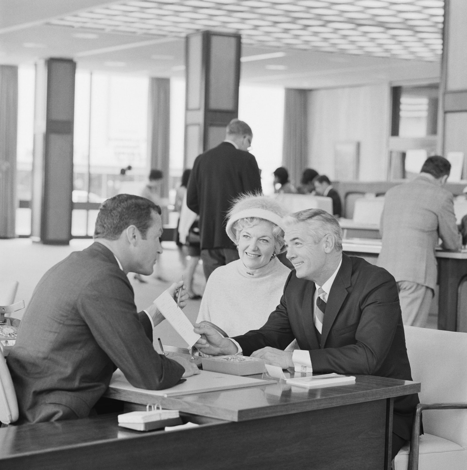 insurance agent sitting at desk with clients