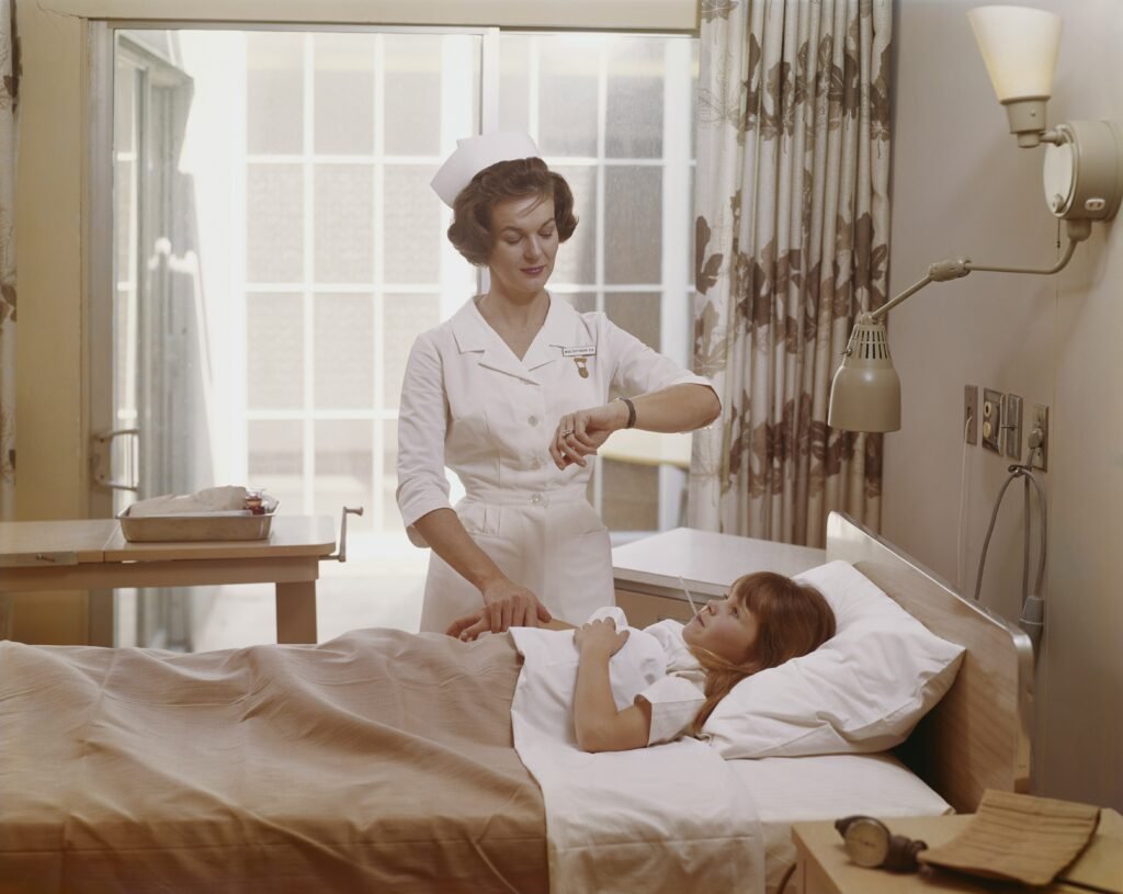 nurse with child in bed